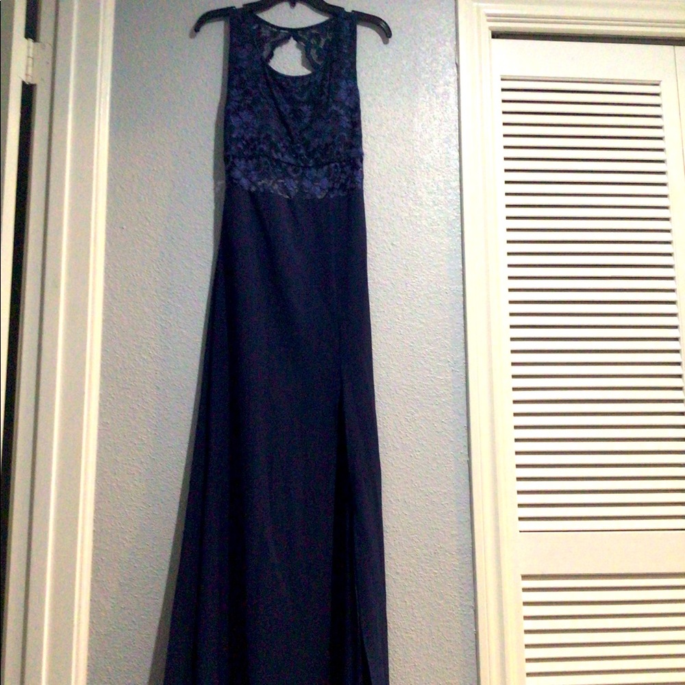Floor-length, backless navy blue formal gown.